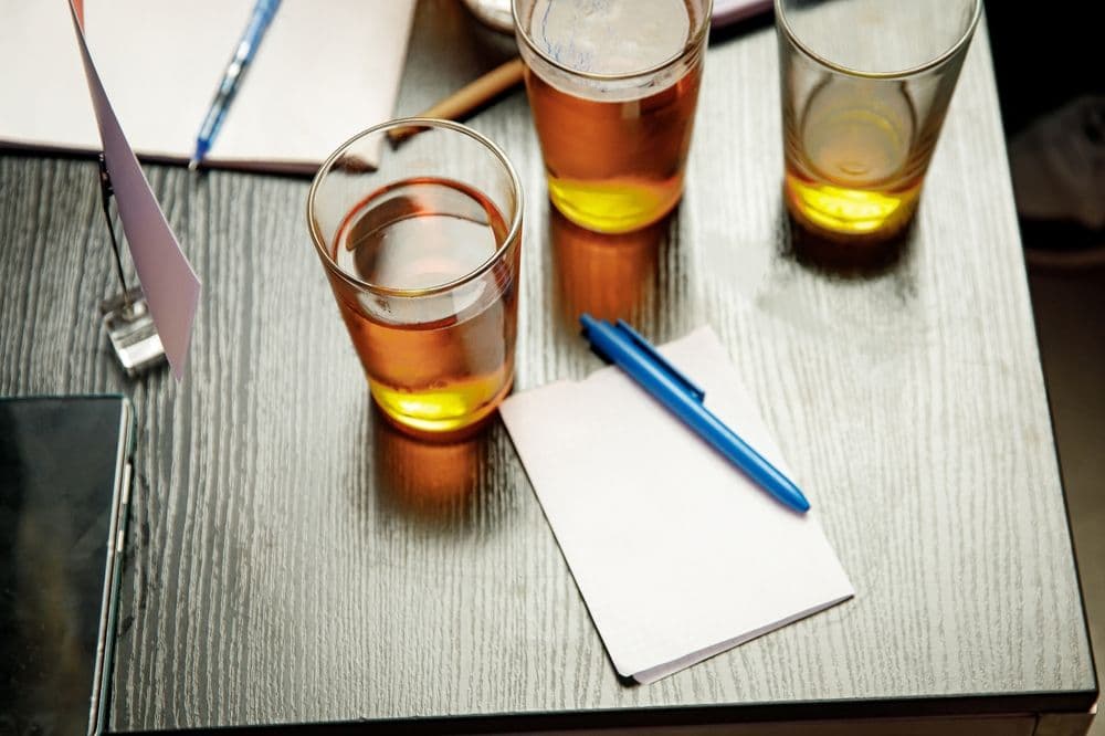 Beer and answer sheets on a table